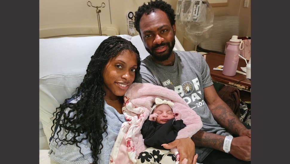 New parents, Taija Lawrence and James Childs, with daughter, Zora.