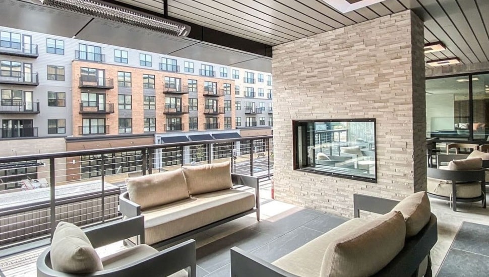 Chair and fireplace on balcony.