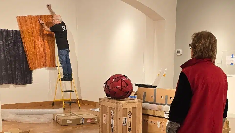Wayne Art Center employees setting up for an exhibit.