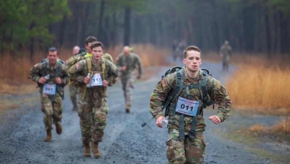 Soldiers in fatigues are out on a hike.