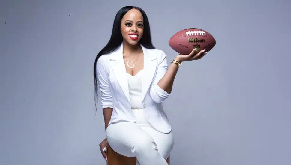 Photo of WilmU Chanelle Reynolds holding a football.