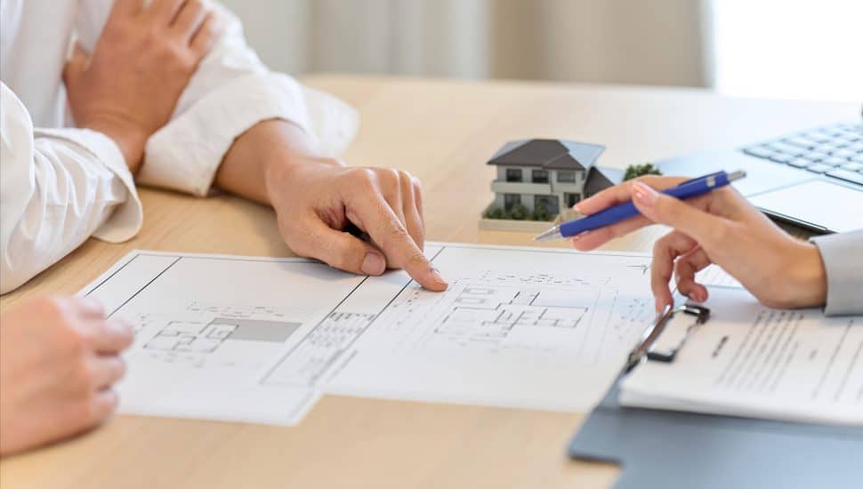 Two people discuss home renovation plans.