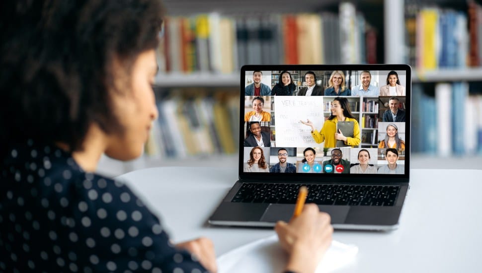 View over shoulder of a female student at a laptop screen.