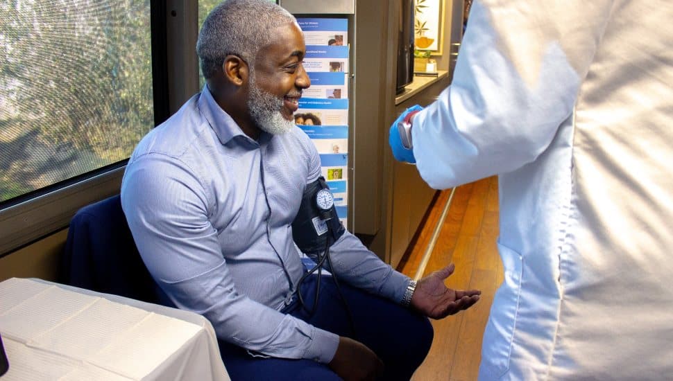 YGBW President and CEO Bertram Lawson gets his blood pressure checked, demonstrating an important tool for heart disease prevention.