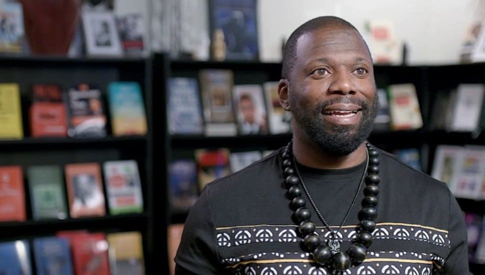 Man in front of books at Black Reserve Bookstore.