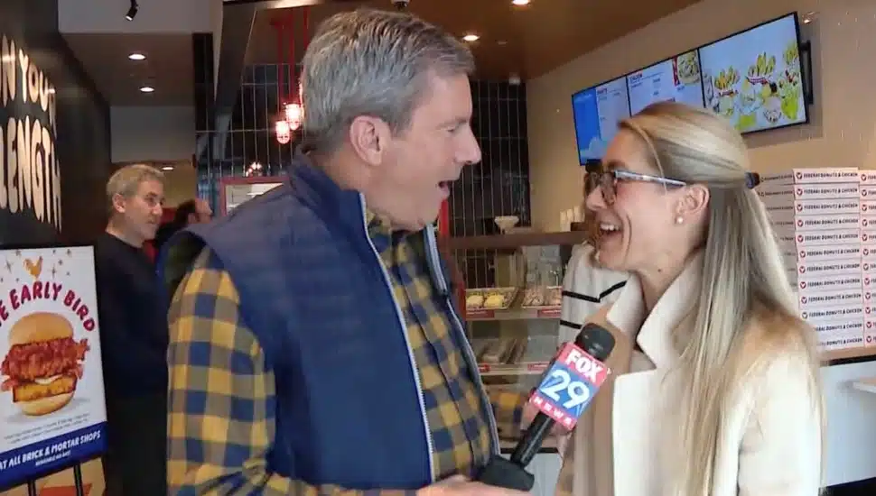 Television reporter interviews bank executive.
