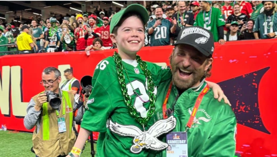 Bradley Cooper holding Declan LeBaron at Eagles Super Bowl.