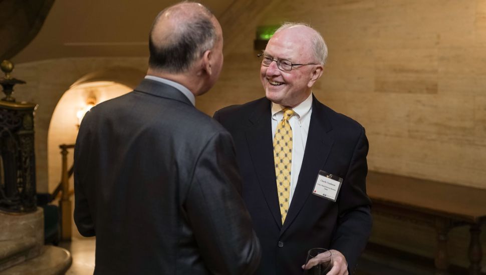 Charlie Tomlinson shaking hands with someone.