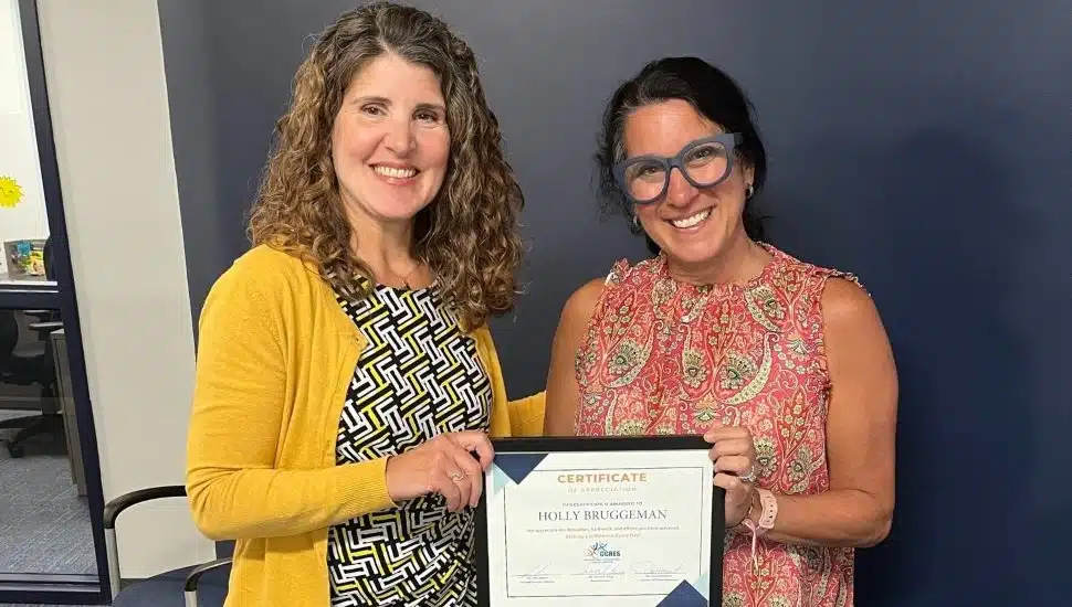 Holly receives a certificate of recognition as she is honored by the CCRES board of directors for her outstanding service.