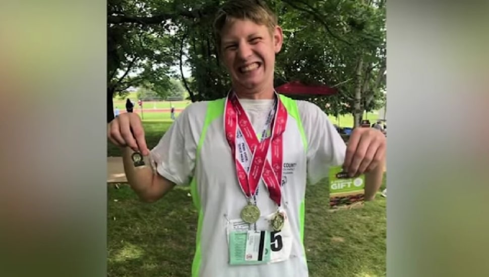 Karl Dickersbach holding medals.