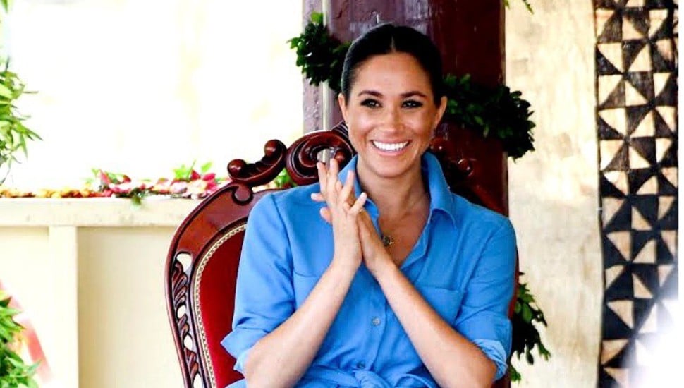 Meghan Markle clasping her hands together.