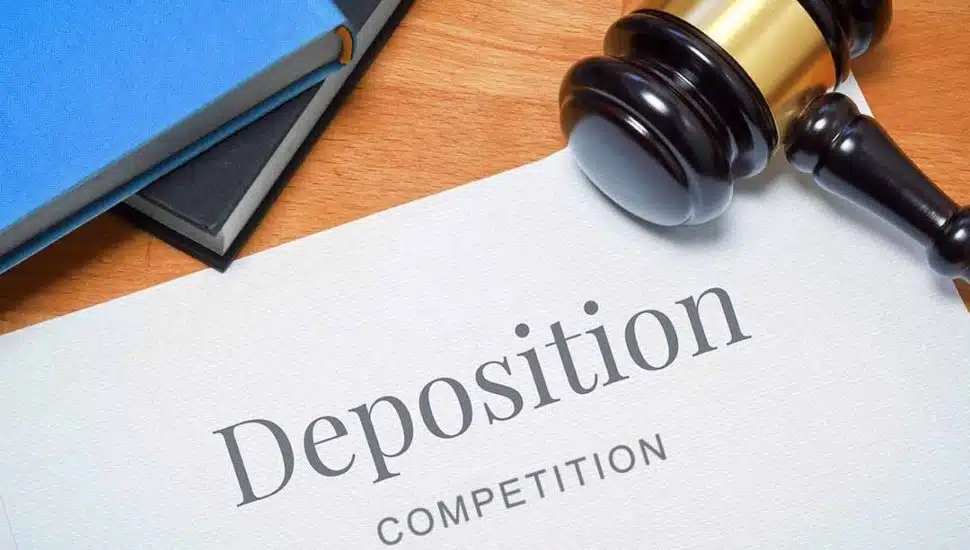 A paper with the word "Deposition" with a gavel on top.