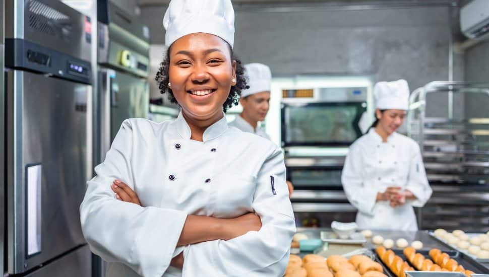 Diverse Group of Culinary Workers – A team of kitchen staff preparing food, representing the workforce opportunities.