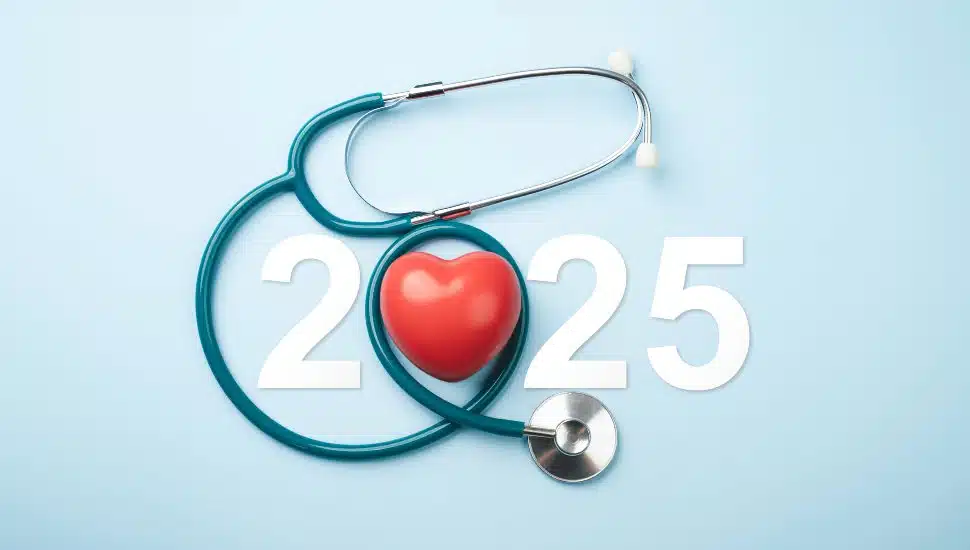A stethoscope forming a heart shape over the year 2025.