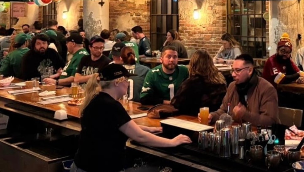 People drinking beer in bar.
