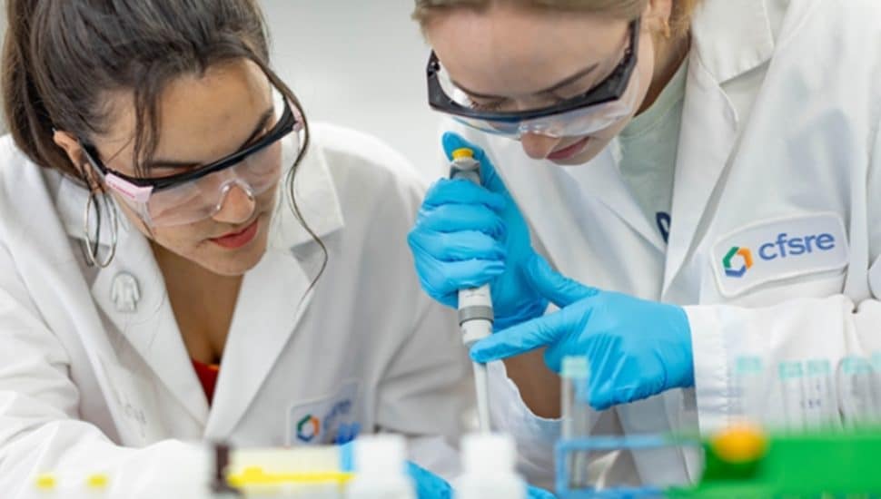 Two people working in a lab.