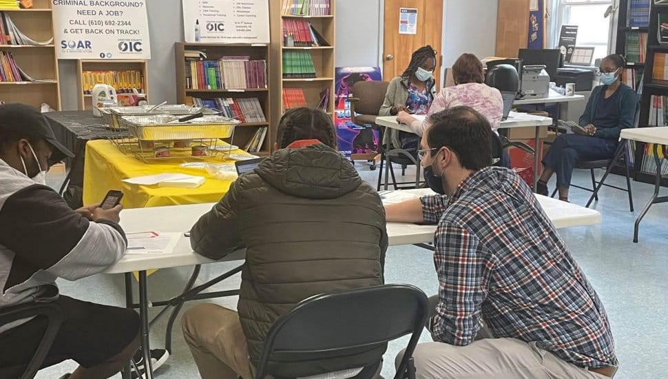 A volunteer for CCOIC working with an adult learner at the Chester County Library.
