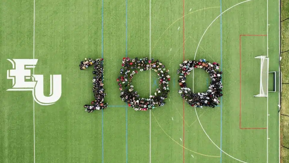 Aerial view of college students forming the number 100.