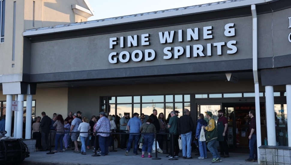 People waiting in line outside of a Fine Wine & Good Spirits store.