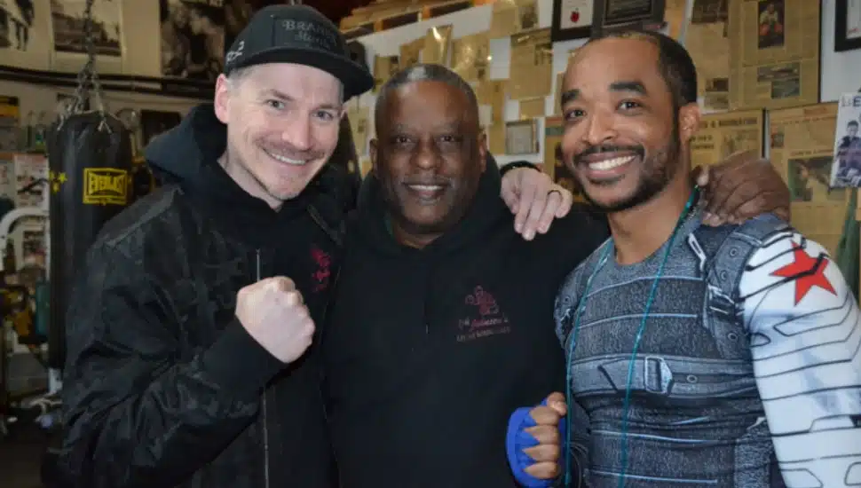 Three men smiling together at Lef Jab Boxing Club.