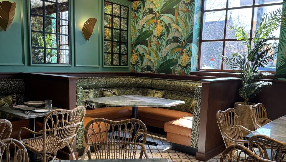 Green and brown furniture accents inside Maison Lotus.
