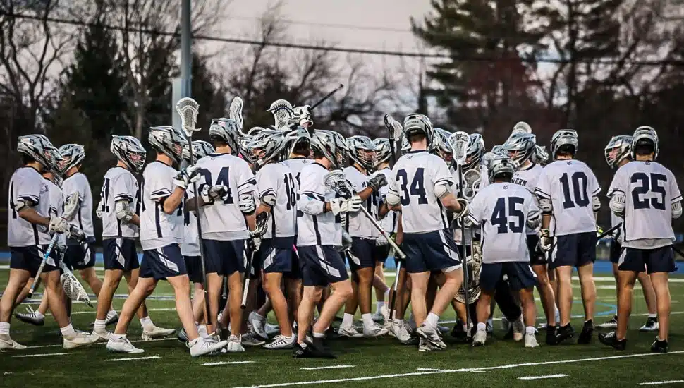 Malvern Prep lacrosse team on field.