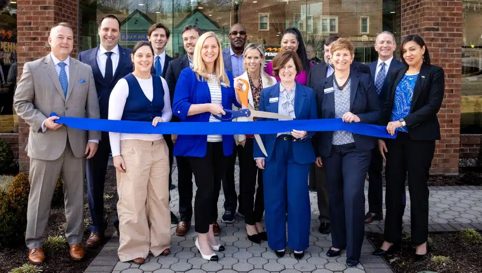 Officials cut ribbon on new bank location.