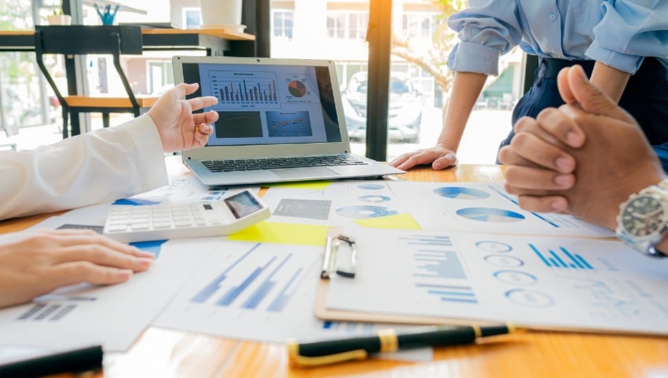 Businesspeople working on a conference room table.