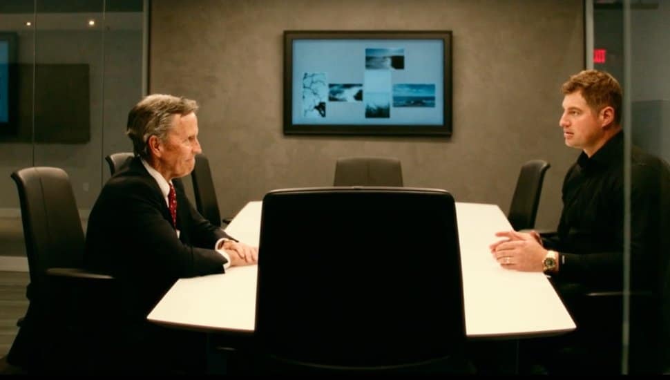 Chris Annas, Chairman, President and CEO of Meridian Bank, sits at a conference room table at Meridian Bank with Brent Celek.