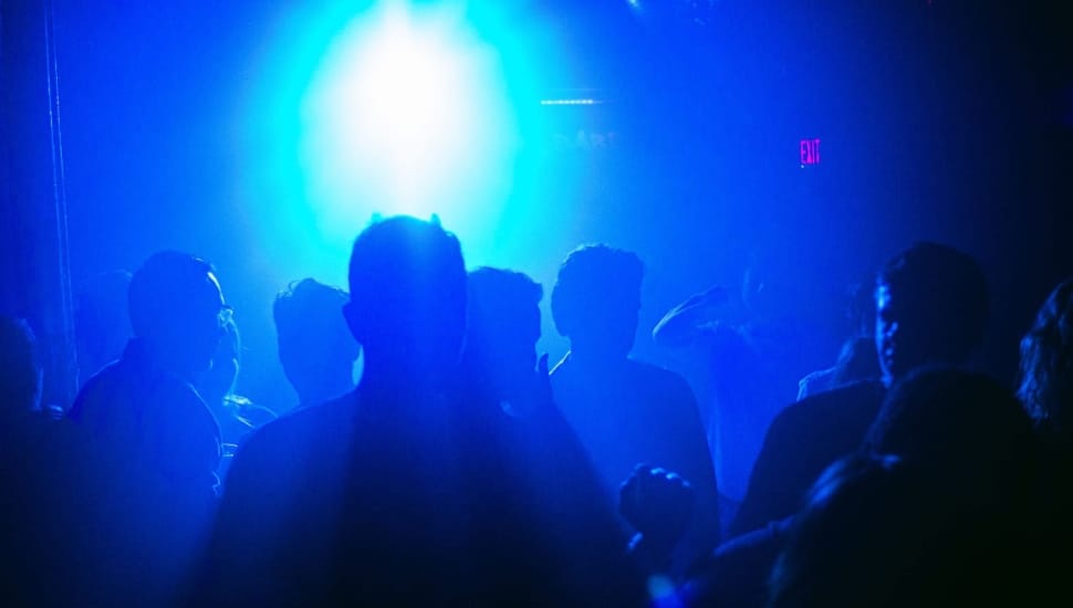 People dancing in blue lights.