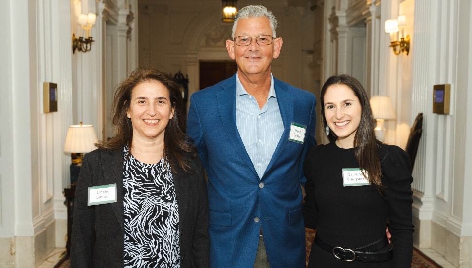 Three co-authors pose for picture at book launch.