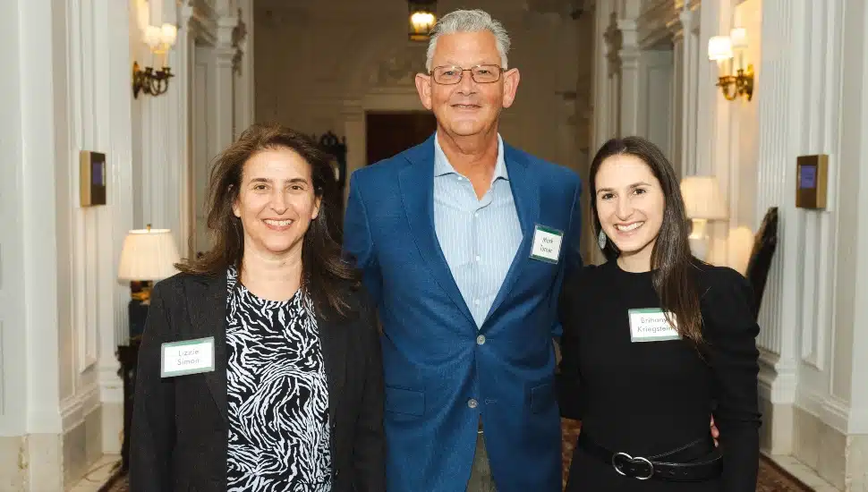 Three co-authors pose for picture at book launch.