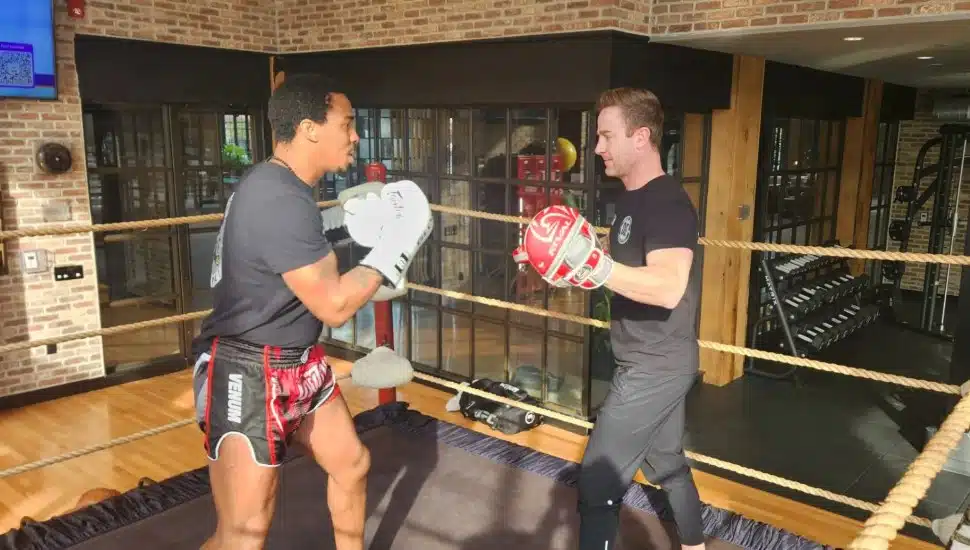 Two men spare in boxing ring.