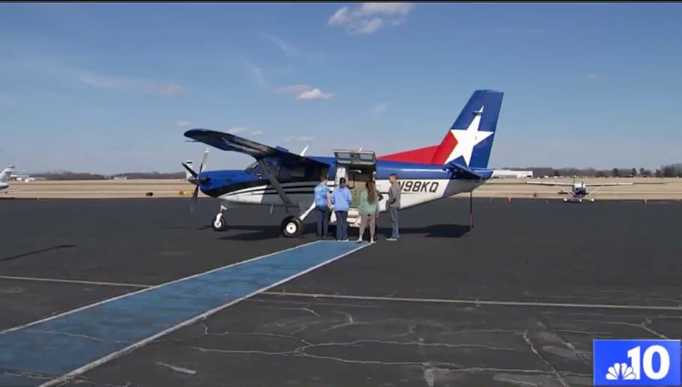 Volunteers going to a plane to see dogs.