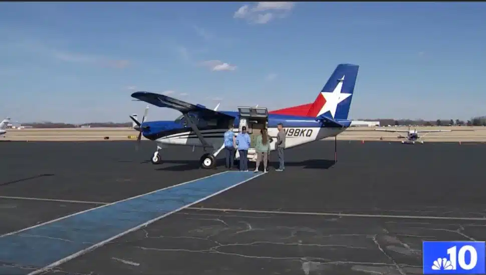 Volunteers going to a plane to see dogs.
