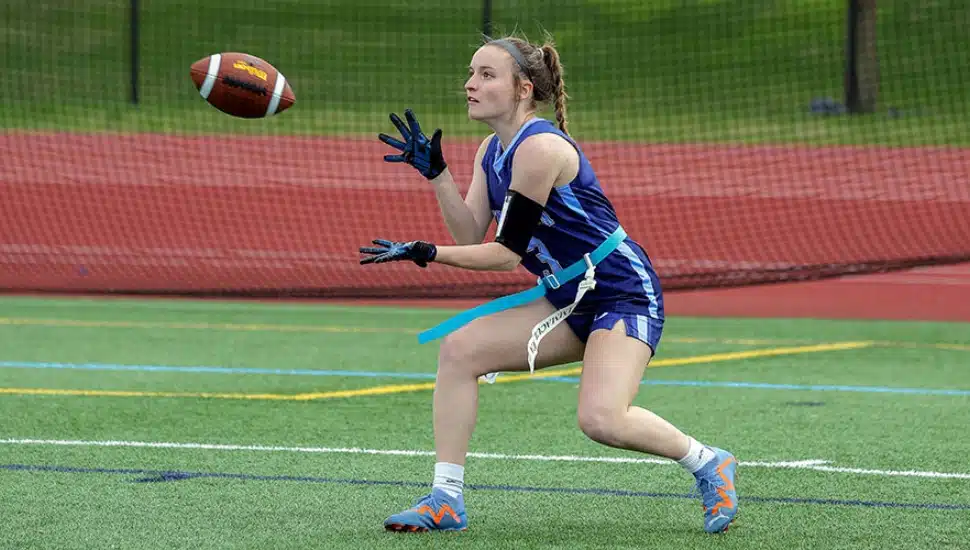 An Immaculata University Women's Flag Football Player catching the ball.