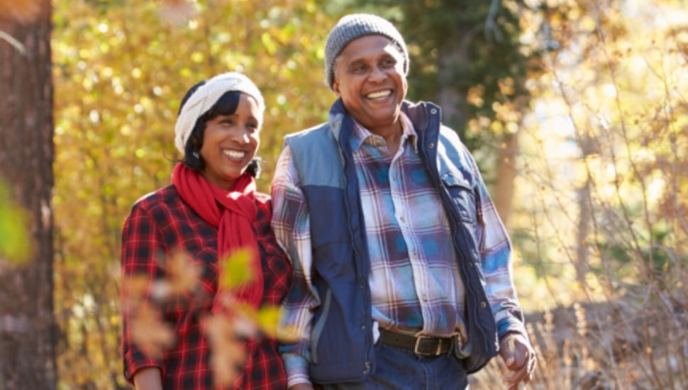 A couple spend some quality time walking in the woods.