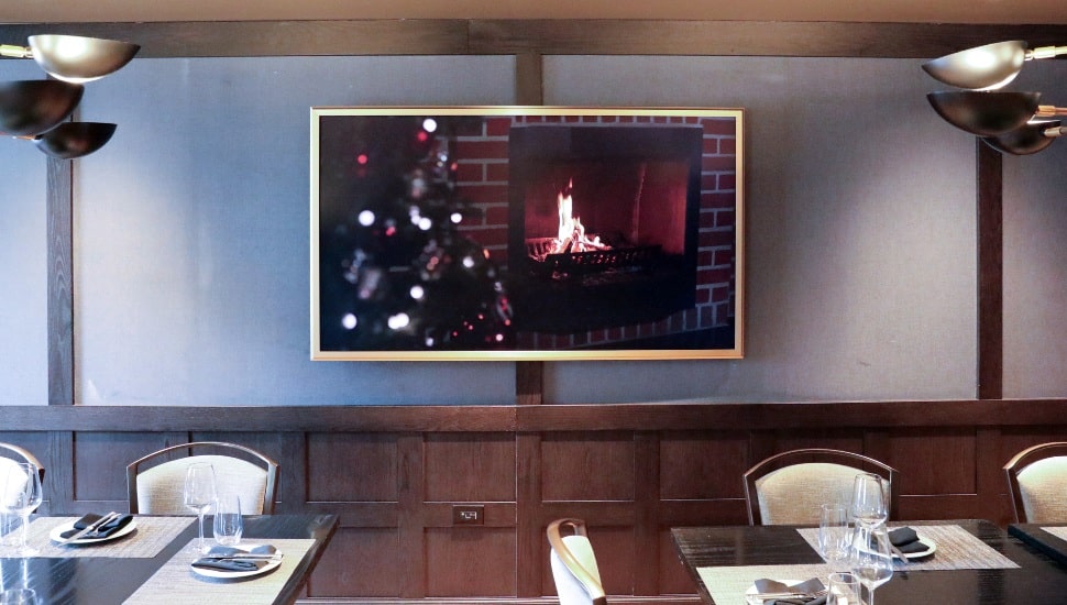 TV on wall in restaurant.