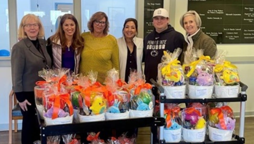 The staff and executives of Arc of Chester County and Partners in Outreach stand with a collection of Easter baskets.