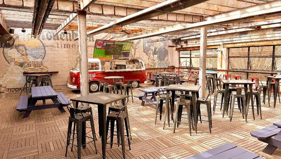 Bistro on Bridge rooftop bar with tables and windows open.