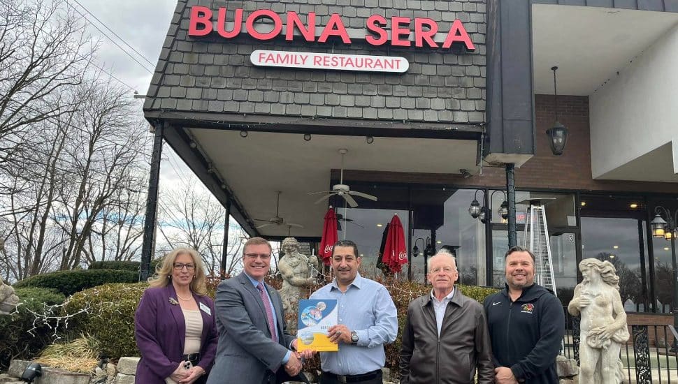 Group of people standing outside Buona Sera restaurant.