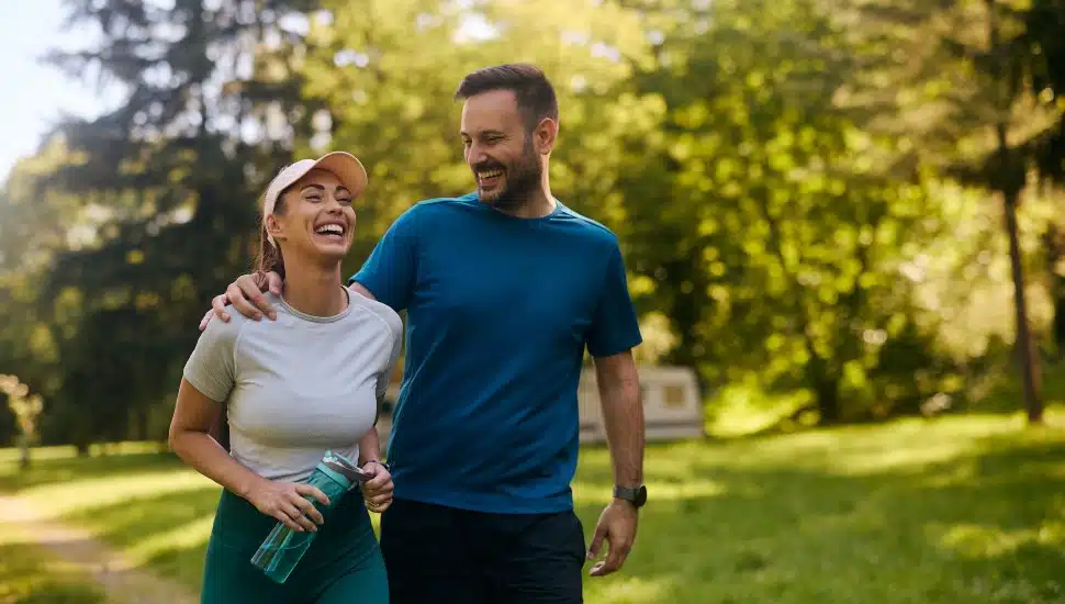 Cheerful couple having fun while exercising in nature.