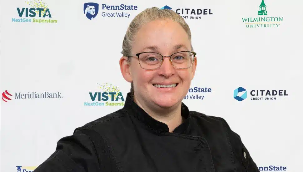 Headshot of Carey Snow: She has light hair pulled back into a pony tail, wears glasses and a black shirt. She is facing the camera and smiling.