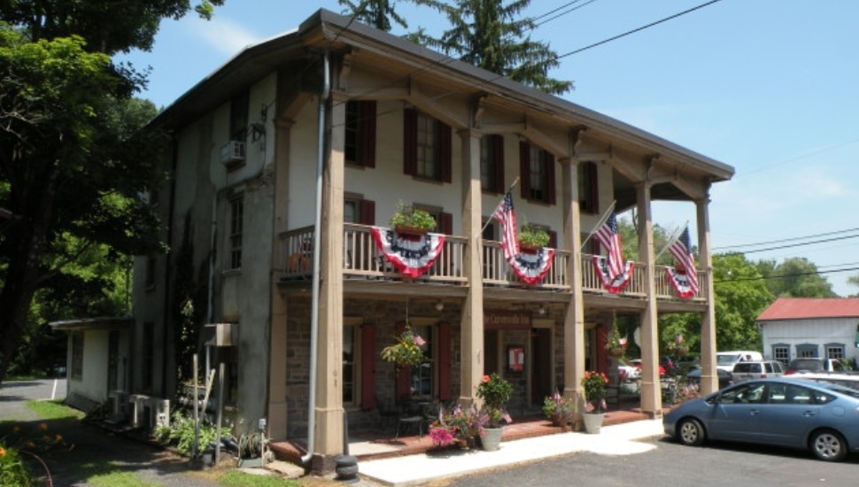 Historic-looking Carverville Inn exterior with car parked in lot.