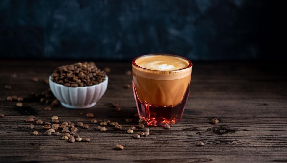 Small cup of coffee and small bowl of coffee beans from Haraz.