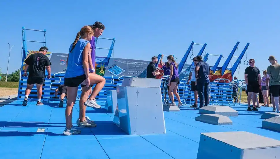 People exercise at outdoor fitness center.