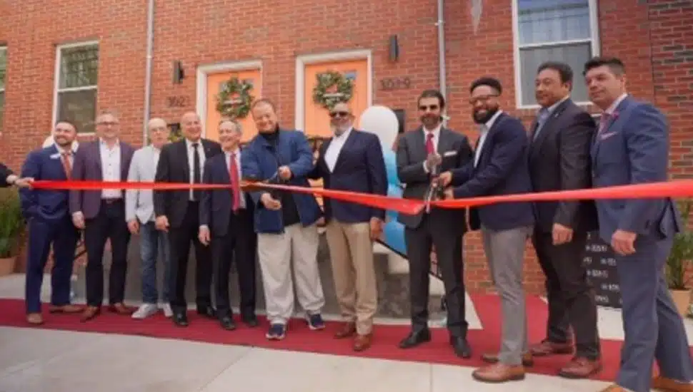 Bank officials cut ribbon for affordable housing.
