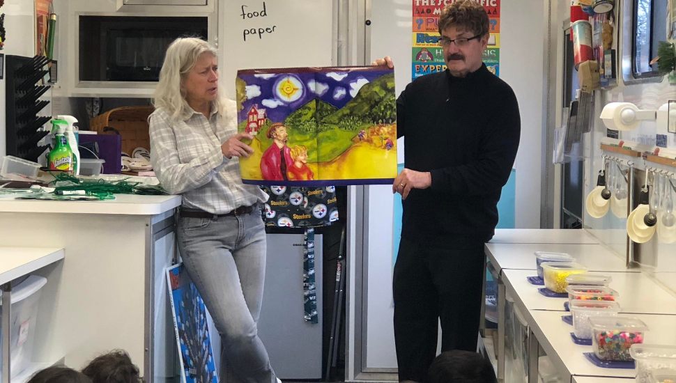 Dr. Raymond Fischer reads to students with Shirley Pituch.