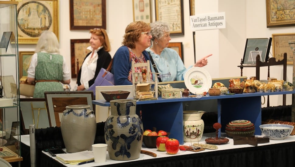 Two older women shop at an antique market.