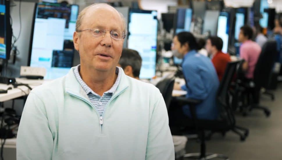 Billionaire Jeff Yass with people working on computers in background.